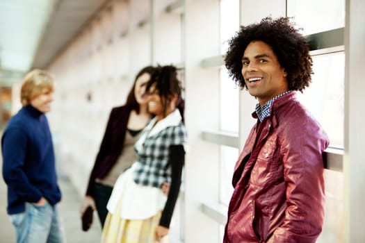 A young African American man with a group of people in the background