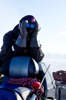 A winter adventure guide scouting the landscape for danger