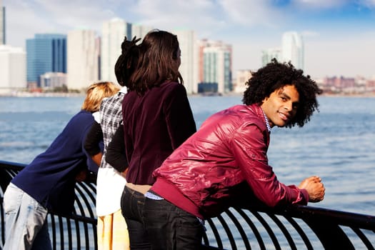 An African American looking at the camera with a group of friends in the background