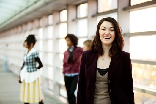 A portrait of a young woman with friends in the background