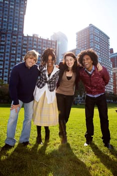A group of friends in the city similing at the camera