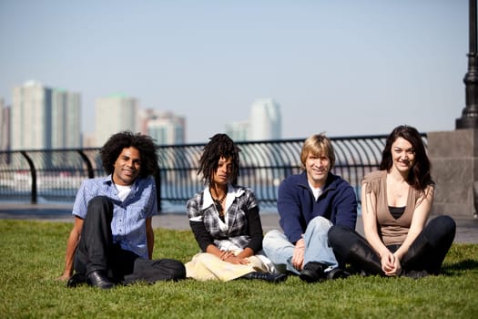 A group of friends in a city park talking and laughing