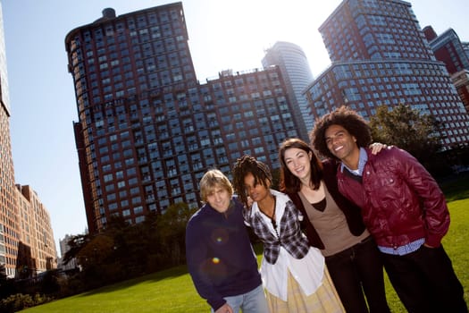 A group of people in front of an apartment building taken into the sun with solar flare