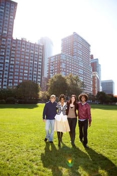 A group of college students in a park - shot against the sun with solar flare