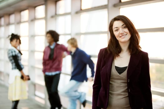 A portrait of a young woman with friends in the background