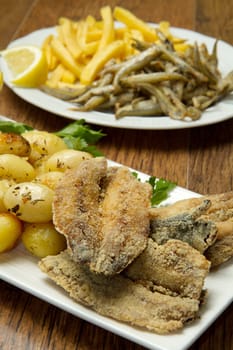 a dish with different fish fried and potate