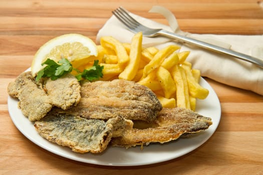 a dish with sardines fried and potate