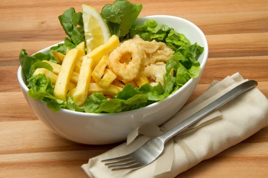 a dish with calamari fried and potatoes
