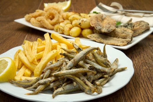 a dish with different fish fried and potate