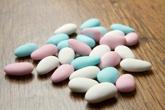 colored jordan almonds on wood background