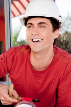Portrait of a happy smiling man wearing a white hard hat