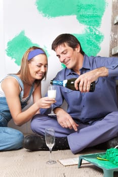 Smiling man pouring champagne in woman's glass