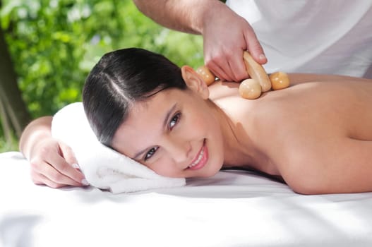 Beautiful young woman getting massage by a therapist