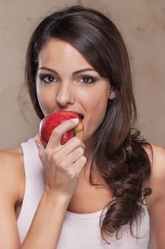 Portrait of beautiful young woman eating an apple