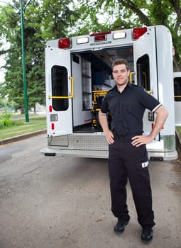 Happy ambulance driver standing for a portrait outdoors