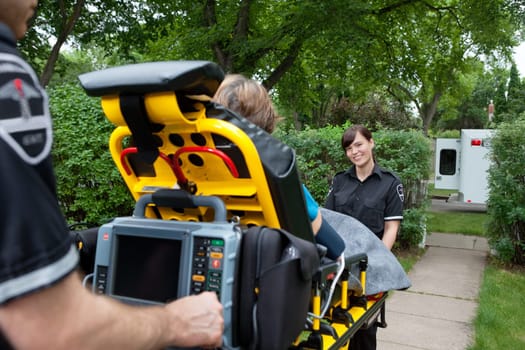 Portrait of woman on emergency medical team taking patient to hospital
