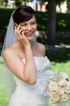 Happy bride talking over cell phone