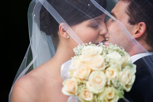 Affectionate newly wed couple kissing