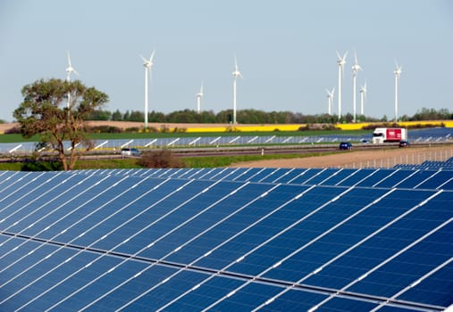 Wind turbines and solar panels in a rapeseed field