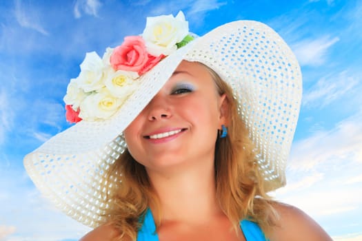 Young funny woman in hat with flowers