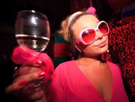 Young woman with glass of wine at party