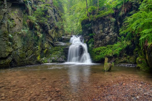 Shot of the fall of water. Stream Huntava - natural area - nature preserve. Resov, Czech republic, Europe.