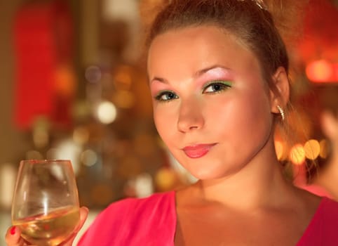 Young woman with glass of wine at party