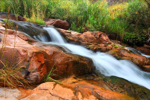 Cascades of a small stream flowing through Grand Canyon National Park on its way to the Colorado River.