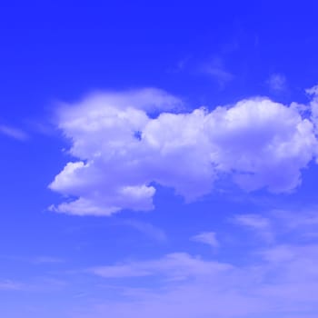 Puffy clouds set against a bright blue sky .