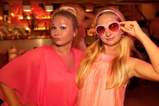 Two young beautiful women at pink party