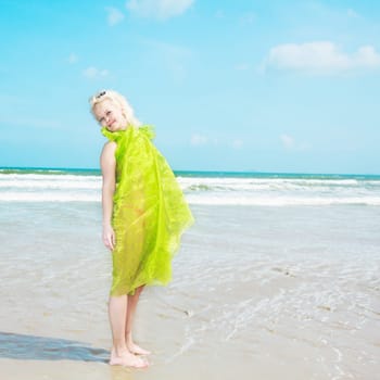 Young woman in green wrap at the  beach