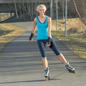 Happy woman roller skating sport smiling in park sunny day