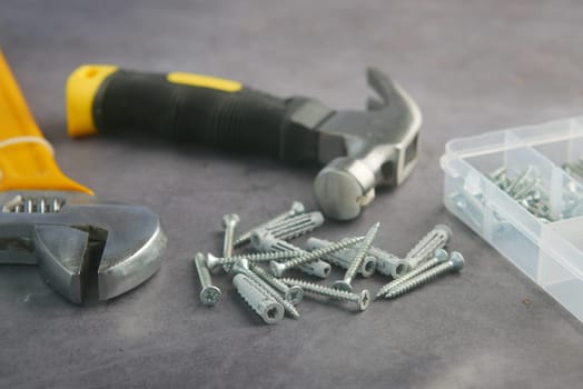 Various tools and screws are displayed on a work surface for repairs.
