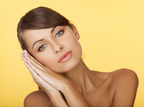 Portrait of beautiful and sexy woman on yellow