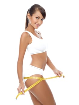 Young beautiful woman with measure tape on white