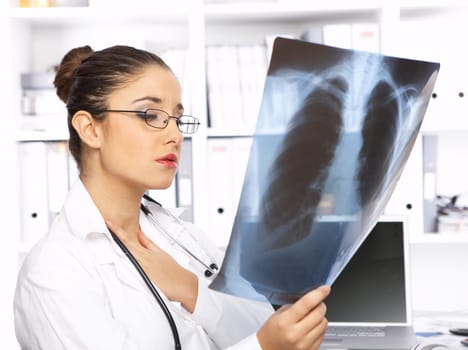 Portrait of female doctor examining x-ray picture