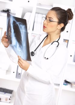 Portrait of female doctor examining x-ray picture