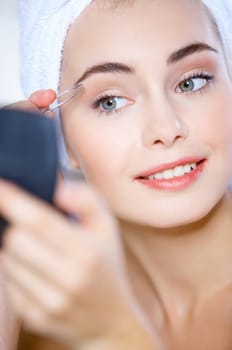 Portrait of cute teenage girl doing morning makeup