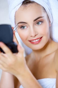 Portrait of cute teenage girl doing morning makeup