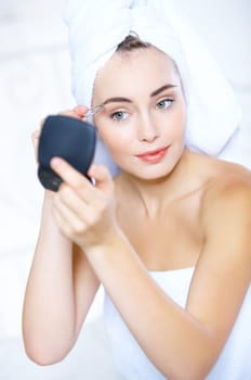 Portrait of cute teenage girl doing morning makeup