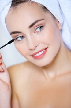 Portrait of cute teenage girl doing morning makeup