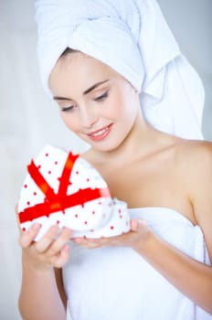 Portrait of cute teenage girl with heart shaped box and rose