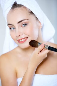 Portrait of cute teenage girl doing morning makeup