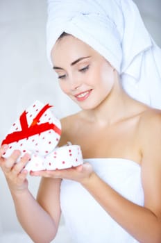Portrait of cute teenage girl with heart shaped box and rose