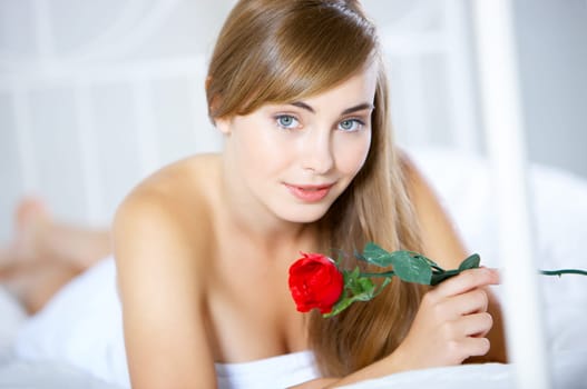 Beautiful teenager on white bed at her home
