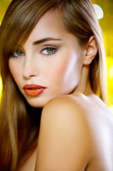 Portrait of beautiful young sexy woman on yellow background