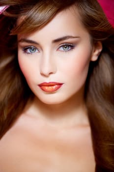 Portrait of beautiful young sexy woman on red background