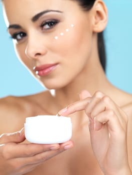 Portrait of beautiful woman, she has cream on her finger