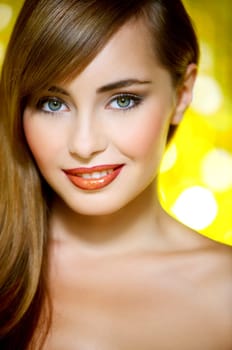 Portrait of beautiful young sexy woman on yellow background