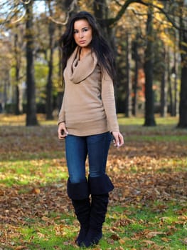 Beautiful woman spending time in park during autumn season